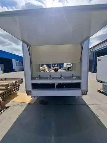 Toiletwagen 12-klepper, achterkant met opengeklapt luik en vier wasbakken